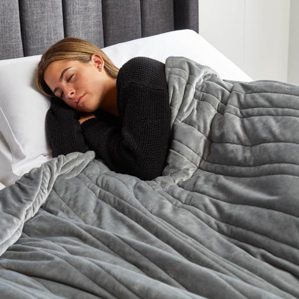 Woman sleeping on Malouf Anchor™ Weighted Blanket at Real Deal Sleep